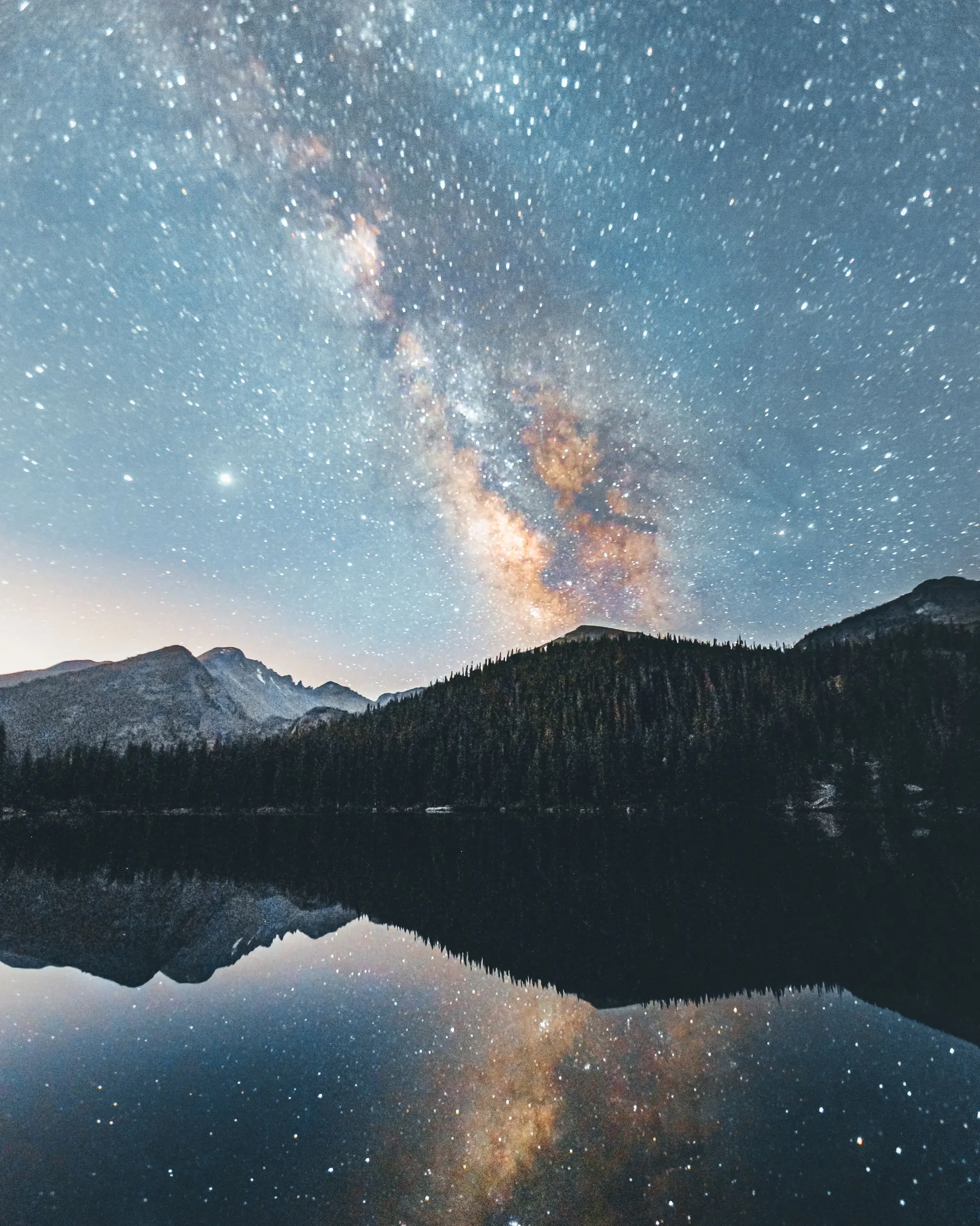 The Milky Way over dark mountains and the lake